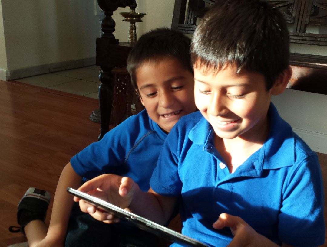 kids playing with virtual dinosaur
